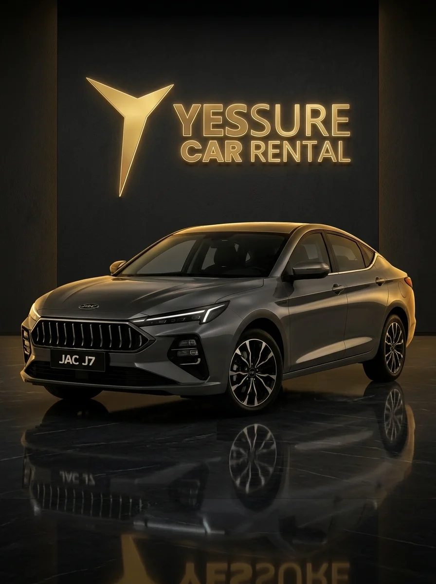 JAC J7 under an illuminated YESSURE CAR RENTAL sign in a dark showroom
